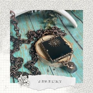 Chunky bronze 36” with a gorgeous black Onyx pendant with attached crystal.